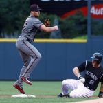 Arizona Diamondbacks second baseman Brandon Drury, left, forces out Colorado Rockies' DJ LeMahieu at second base on the front end of a double play hit into by Nolan Arenado to end the bottom of the first inning of a baseball game Wednesday, June 21, 2017, in Denver. (AP Photo/David Zalubowski)