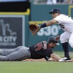 Detroit Tigers first baseman Miguel Cabrera waits on the throw as Arizona Diamondbacks' Paul Goldschmidt dives back on a pickoff attempt during the first inning of a baseball game, Wednesday, June 14, 2017, in Detroit. (AP Photo/Carlos Osorio)