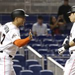 Miami Marlins' Giancarlo Stanton, left, greets Christian Yelich after they scored on a two-run home run by Yelich during the first inning of a baseball game against the Arizona Diamondbacks, Friday, June 2, 2017, in Miami. (AP Photo/Lynne Sladky)