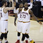 Cleveland Cavaliers forward LeBron James (23) celebrates with Kevin Love (0) and Kyrie Irving (2) during the first half against the Golden State Warriors in Game 4 of basketball's NBA Finals in Cleveland, Friday, June 9, 2017. (AP Photo/Ron Schwane)