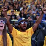 Golden State Warriors employees watch television coverage of Game 4 of basketball's NBA Finals between the Warriors and the Cleveland Cavaliers, Friday, June 9, 2017, at Oracle Arena in Oakland, Calif. (AP Photo/Marcio Jose Sanchez)