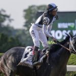 Jose Ortiz rises from his saddle after riding Tapwrit to victory in the 149th running of the Belmont Stakes horse race, Saturday, June 10, 2017, in Elmont, N.Y. (AP Photo/Peter Morgan)