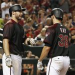 Arizona Diamondbacks' Robbie Ray (38) celebrates after scoring against the Philadelphia Phillies, with Paul Goldschmidt, left, during the fifth inning of a baseball game Saturday, June 24, 2017, in Phoenix. (AP Photo/Ross D. Franklin)