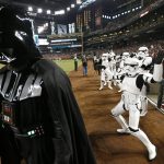 A stormtrooper makes fun of Darth Vader, left, on "Star Wars Night" prior to a baseball game between the Arizona Diamondbacks and the Philadelphia Phillies, Saturday, June 24, 2017, in Phoenix. (AP Photo/Ross D. Franklin)
