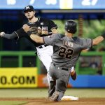 Miami Marlins shortstop JT Riddle throws to first to put out Brandon Drury to complete a double play, after forcing out Jake Lamb (22) during the fifth inning of a baseball game, Saturday, June 3, 2017, in Miami. The Marlins defeated the Diamondbacks 3-0. (AP Photo/Wilfredo Lee)