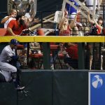 Milwaukee Brewers' Keon Broxton crashes into the fence as he jumps in vain to catch a home run by Arizona Diamondbacks' Brandon Drury during the seventh inning of a baseball game Sunday, June 11, 2017, in Phoenix. (AP Photo/Ross D. Franklin)