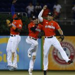 Miami Marlins' Marcell Ozuna, left, Christian Yelich, center, and Giancarlo Stanton celebrate after they defeated the Arizona Diamondbacks in a baseball game, Sunday, June 4, 2017, in Miami. (AP Photo/Wilfredo Lee)