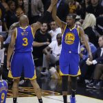 Golden State Warriors forward David West (3) and Kevin Durant (35) react during the first half against the Cleveland Cavaliers in Game 4 of basketball's NBA Finals in Cleveland, Friday, June 9, 2017. (AP Photo/Ron Schwane)
