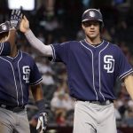 San Diego Padres' Wil Myers high-fives teammates after scoring on a base hit by teammate Austin Hedges during the first inning of a baseball game against the Arizona Diamondbacks, Thursday, June 8, 2017, in Phoenix. (AP Photo/Matt York)