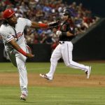Philadelphia Phillies' Maikel Franco follows through on a throw to first base that put out Arizona Diamondbacks' Chris Owings as Diamondbacks' Paul Goldschmidt, right, watches during the fourth inning of a baseball game Saturday, June 24, 2017, in Phoenix. (AP Photo/Ross D. Franklin)