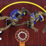 Cleveland Cavaliers guard Kyrie Irving (2) shoots on Golden State Warriors forward Andre Iguodala, second from right, during the first half of Game 4 of basketball's NBA Finals in Cleveland, Friday, June 9, 2017. (AP Photo/Ron Schwane, Pool)
