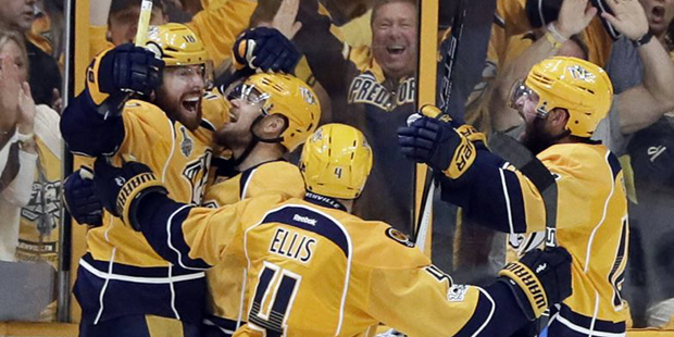 Nashville Predators right wing James Neal, left, celebrates with teammates his goal against the Pit...