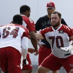 Arizona Cardinals lineman Evan Boehm (70) moves into position to block Dorian Johnson (64) and Jonathan McLaughlin, middle, as offensive linemen run drills during an NFL football organized team activity, Thursday, June 1, 2017, at the team training facility in Tempe, Ariz. (AP Photo/Ross D. Franklin)