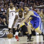 Cleveland Cavaliers guard Kyrie Irving (2) drives on Golden State Warriors guard Klay Thompson (11) during the first half of Game 4 of basketball's NBA Finals in Cleveland, Friday, June 9, 2017. (AP Photo/Tony Dejak)