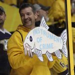 A Nashville Predators fan holds up a catfish sign before Game 3 of the NHL hockey Stanley Cup Finals Saturday, June 3, 2017, in Nashville, Tenn. (AP Photo/Mark Humphrey)