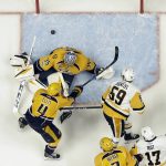 Pittsburgh Penguins center Jake Guentzel (59) shoots the puck past Nashville Predators goalie Pekka Rinne, of Finland, (35) and Ryan Ellis (4) for a goal during the first period of Game 3 of the NHL hockey Stanley Cup Finals Saturday, June 3, 2017, in Nashville, Tenn. (AP Photo/Mark Humphrey)
