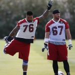Arizona Cardinals offensive linemen Mike Iupati (76) and Tony Bergstrom (67) wait their turn to run drills during an NFL football organized team activity, Thursday, June 1, 2017, at the team training facility in Tempe, Ariz. (AP Photo/Ross D. Franklin)
