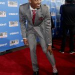 Louisville's Donovan Mitchell shows off his socks while stopping for photos on the red carpet before the start of the NBA basketball draft, Thursday, June 22, 2017, in New York. (AP Photo/Frank Franklin II)