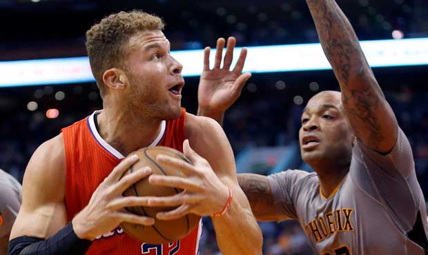 Los Angeles Clippers' Blake Griffin (32) protects the basketball as he drives to the basket, while ...