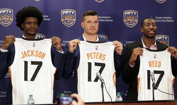 Phoenix Suns NBA basketball draft picks Josh Jackson, Alec Peters and Davon Reed, from left, hold t...