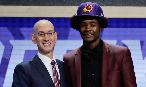 Kansas' Josh Jackson, right, poses for a photo with NBA Commissioner Adam Silver after being select...