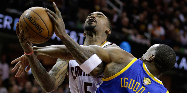 Golden State Warriors forward Andre Iguodala (9) fouls Cleveland Cavaliers guard J.R. Smith (5) dur...