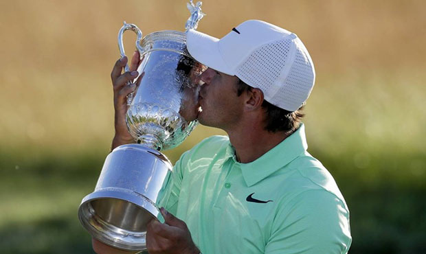 Brooks Koepka kisses the winning trophy after the U.S. Open golf tournament Sunday, June 18, 2017, ...