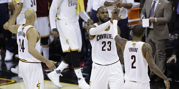 Cleveland Cavaliers forward LeBron James (23) and teammate Kyrie Irving (2) celebrate during the fi...