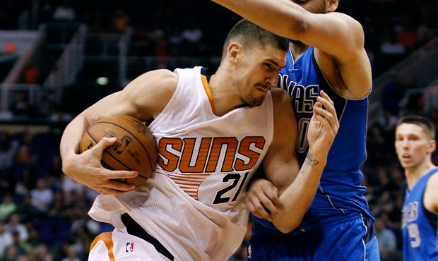 Phoenix Suns center Alex Len (21) drives to the basket through Dallas Mavericks' A.J. Hammonds duri...