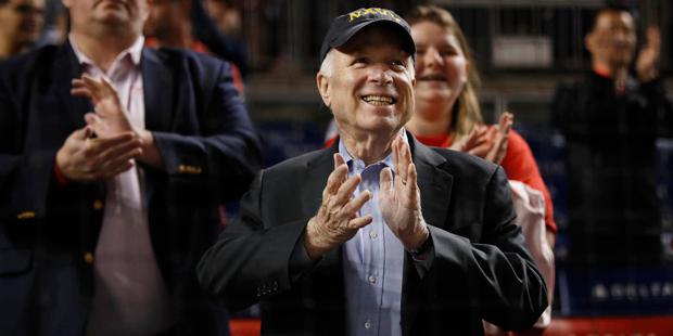 Republican presidential candidate, Sen. John McCain, R-Ariz., center, cheers as he watches a baseba...