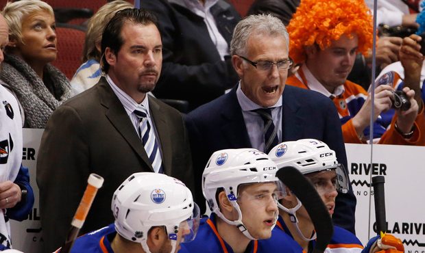 Edmonton Oilers general manager Craig MacTavish, right, shouts instructions to Oilers players as so...