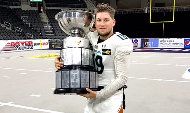 Arizona Rattlers quarterback Cody Sokol poses with the Indoor Football League United Bowl trophy Sa...