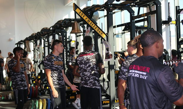 Arizona State football players use the benches in the brand new weight room on Wednesday (Photo by ...