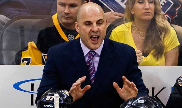 Pittsburgh Penguins assistant coach Rick Tocchet talks with linesman Steve Barton (59) during the t...