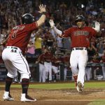 Arizona Diamondbacks' Ketel Marte (4) smiles as he celebrates his two-run inside-the-park home run against the Atlanta Braves with Daniel Descalso (3) during the third inning of a baseball game Wednesday, July 26, 2017, in Phoenix. (AP Photo/Ross D. Franklin)