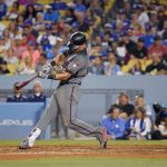 Arizona Diamondbacks' Jake Lamb hits a solo home run as Los Angeles Dodgers catcher Austin Barnes watches during the fifth inning of a baseball game, Thursday, July 6, 2017, in Los Angeles. (AP Photo/Mark J. Terrill)
