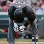Arizona Diamondbacks' J.D. Martinez doubles over in pain after being struck while swinging at a pitch from Cincinnati Reds starting pitcher Tim Adleman in the fourth inning of a baseball game, Wednesday, July 19, 2017, in Cincinnati. (AP Photo/John Minchillo)