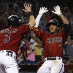 Arizona Diamondbacks' Ketel Marte (4) smiles as he celebrates his two-run inside-the-park home run with Daniel Descalso (3) during the third inning of a baseball game against the Atlanta Braves, Wednesday, July 26, 2017, in Phoenix. (AP Photo/Ross D. Franklin)