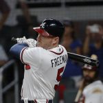 Atlanta Braves' Freddie Freeman (5) follows through on a two-run base hit in the eighth inning of a baseball game against the Arizona Diamondbacks, Friday, July 14, 2017, in Atlanta. (AP Photo/John Bazemore)