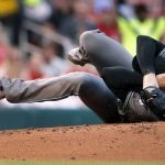 Arizona Diamondbacks starting pitcher Robbie Ray falls to the ground after being hit on the head by a ball back to the mound by St. Louis Cardinals' Luke Voit during the second inning of a baseball game Friday, July 28, 2017, in St. Louis. Ray left the game. (AP Photo/Jeff Roberson)