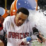 Arizona Diamondbacks' Ketel Marte gets a bucket of ice poured on him by teammate David Peralta, left, after Marte's walk off single against the Colorado Rockies after a baseball game, Sunday, July 2, 2017, in Phoenix. The Diamondbacks defeated the Rockies 4-3. (AP Photo/Ross D. Franklin)