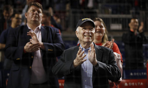 Sen. John McCain, R-Ariz., applauds during the break in the seventh inning of a baseball game betwe...