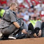 Arizona Diamondbacks starting pitcher Robbie Ray, right, is checked on by teammate Chris Herrmann after being hit on the head by a ball back to the mound by St. Louis Cardinals' Luke Voit during the second inning of a baseball game Friday, July 28, 2017, in St. Louis. Ray left the game. (AP Photo/Jeff Roberson)