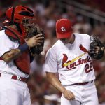 St. Louis Cardinals relief pitcher Seung-Hwan Oh, right, talks with catcher Yadier Molina during the seventh inning of a baseball game against the Arizona Diamondbacks, Friday, July 28, 2017, in St. Louis. (AP Photo/Jeff Roberson)