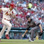 Arizona Diamondbacks starting pitcher Zack Greinke, right, picks up a slow-roller by St. Louis Cardinals' Mike Leake before throwing Leake out at first during the second inning of a baseball game Saturday, July 29, 2017, in St. Louis. (AP Photo/Jeff Roberson)