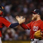 Washington Nationals' Sean Doolittle, right, celebrates the final out against the Arizona Diamondbacks with catcher Matt Wieters, left, during the ninth inning of a baseball game Saturday, July 22, 2017, in Phoenix. (AP Photo/Ross D. Franklin)