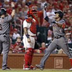 Arizona Diamondbacks' Ketel Marte (4) is congratulated by Daniel Descalso (3) as St. Louis Cardinals catcher Yadier Molina waits after Marte hit a two-run home run during the eighth inning of a baseball game Saturday, July 29, 2017, in St. Louis. (AP Photo/Jeff Roberson)