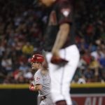 Cincinnati Reds' Scooter Gennett rounds the bases after hitting a solo home run as Arizona Diamondbacks starting pitcher Taijuan Walker looks down during the fifth of a baseball game, Saturday, July 8, 2017, in Phoenix. (AP Photo/Matt York)