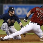 Arizona Diamondbacks' Paul Goldschmidt (44) slides into second base with a double ahead of a tag from Atlanta Braves' Dansby Swanson, left, during the first inning of a baseball game Wednesday, July 26, 2017, in Phoenix. (AP Photo/Ross D. Franklin)