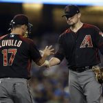 Arizona Diamondbacks manager Torey Lovullo (17) pulls starting pitcher Zack Godley, right, during a pitching change in the sixth inning of the team's baseball game against the Los Angeles Dodgers in Los Angeles, Wednesday, July 5, 2017. (AP Photo/Alex Gallardo)